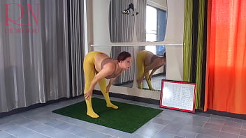 Housewife Regina Noir. Yoga in yellow tights doing yoga in the gym. 1