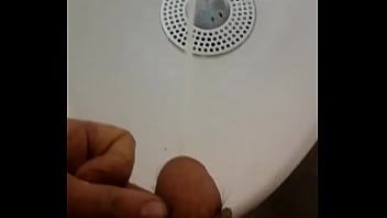 Pee Peeing into a urinal in work